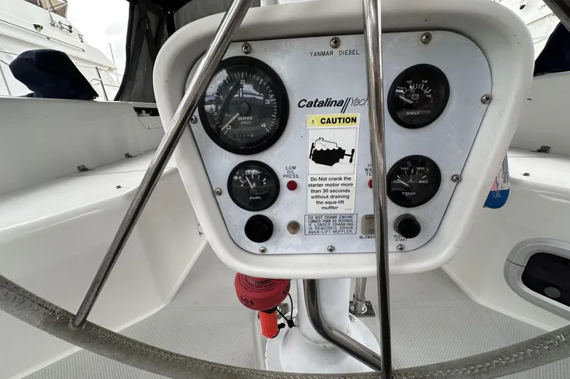 Slide: The Image of Control panel of a 1999 Catalina 42 MkII yacht with gauges and caution label. - 48