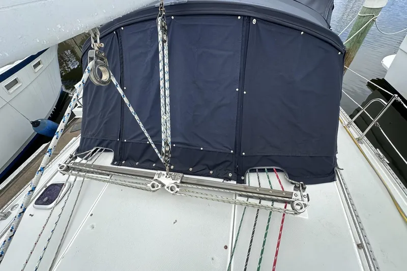 Slide: The Image of 1999 Catalina 42 MkII sailboat deck with blue canvas cover and rigging details. - 52