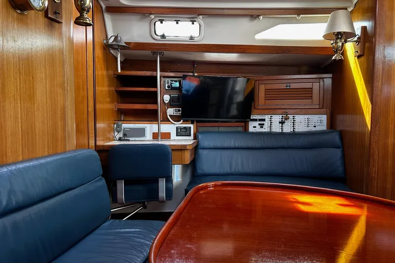 Slide: The Image of Interior of 1999 Catalina 42 MkII yacht with wood paneling and blue seating. - 6