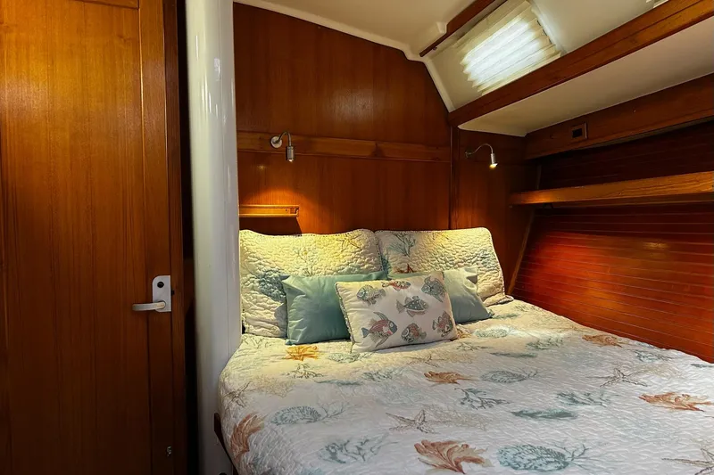 Slide: The Image of Cozy cabin interior of 1999 Catalina 42 MkII sailboat with nautical-themed bedding. - 9