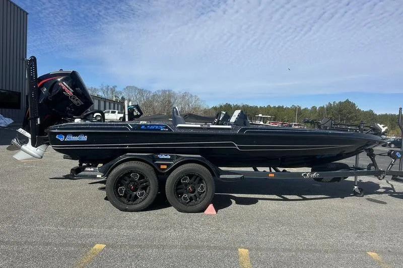 The Image of 2026 Bass Cat Lynx STS boat on trailer in parking lot. - 0