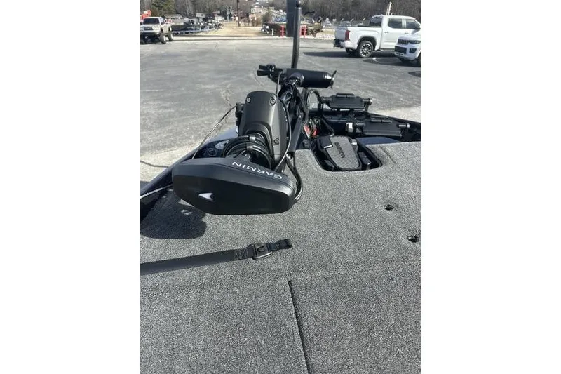 Slide: The Image of 2026 Bass Cat Lynx STS boat deck with Garmin equipment, parked in a lot. - 1