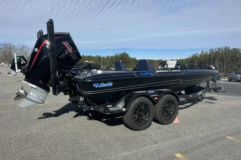 Slide: The Image of 2026 Bass Cat Lynx STS boat with powerful outboard motor on a trailer. - 6