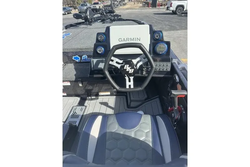 Slide: The Image of 2026 Bass Cat Lynx STS boat cockpit with Garmin navigation system and modern steering wheel. - 8