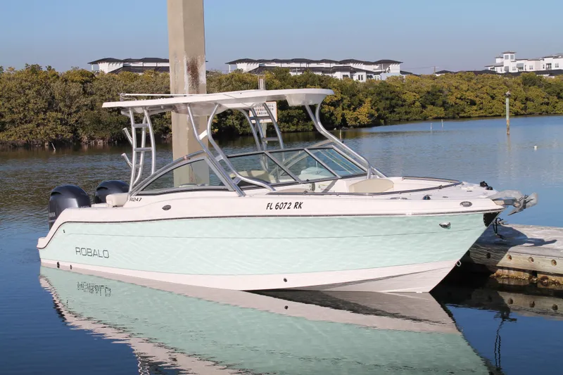 The Image of 2016 Robalo R247 Dual Console boat docked on calm water. - 1