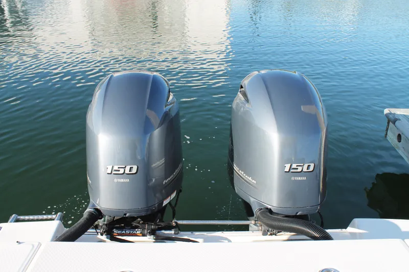 Slide: The Image of Twin Yamaha 150 outboard engines on a 2016 Robalo R247 Dual Console boat. - 10