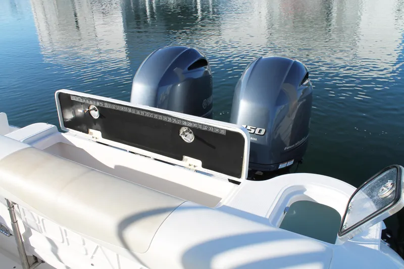Slide: The Image of 2016 Robalo R247 Dual Console boat with twin Yamaha 150 engines on calm water. - 12