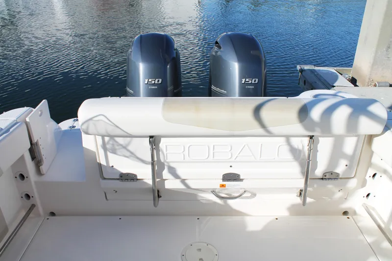 Slide: The Image of 2016 Robalo R247 Dual Console boat with twin Yamaha 150 engines on calm water. - 13