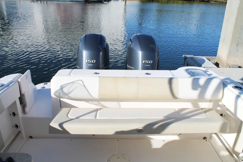 Slide: The Image of 2016 Robalo R247 Dual Console boat with twin Yamaha 150 engines on calm water. - 14