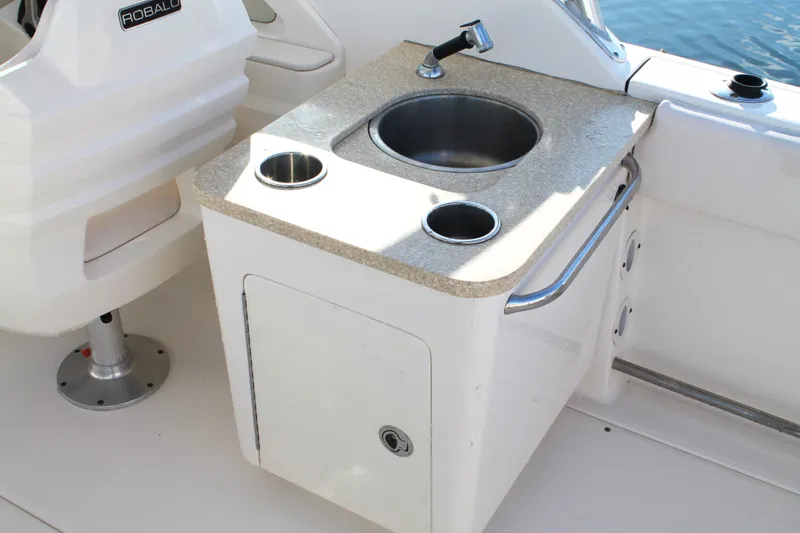 Slide: The Image of 2016 Robalo R247 Dual Console boat sink and countertop detail. - 18