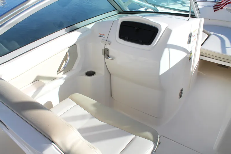 Slide: The Image of 2016 Robalo R247 Dual Console interior with seating and storage compartment. - 24