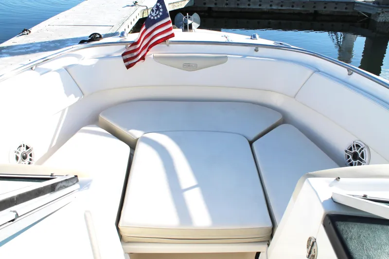 Slide: The Image of 2016 Robalo R247 Dual Console boat with cushioned seating and American flag. - 29