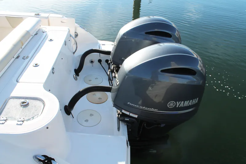 Slide: The Image of 2016 Robalo R247 Dual Console with twin Yamaha outboard engines on water. - 9