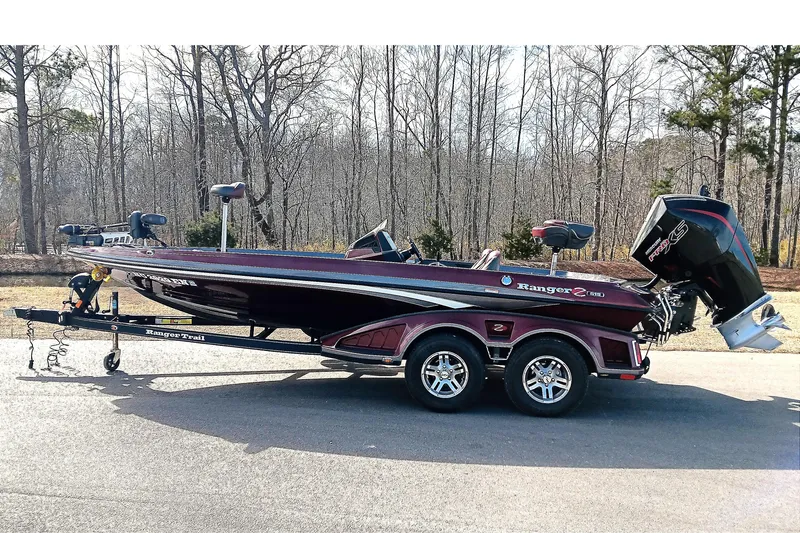 The Image of 2020 Ranger Z519 boat on trailer, parked outdoors, with trees in the background. - 1