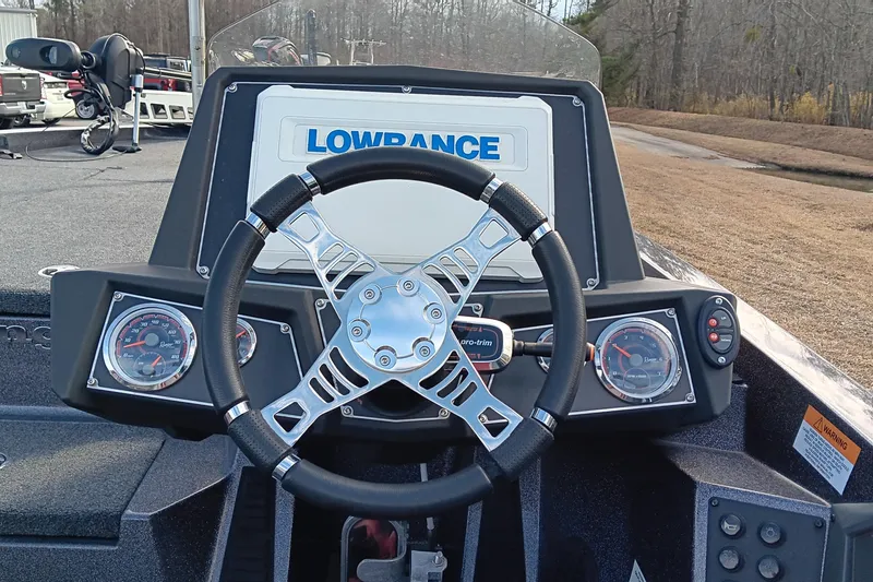 Slide: The Image of 2020 Ranger Z519 boat dashboard with steering wheel and Lowrance display. - 12