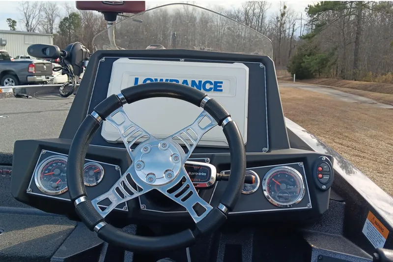 Slide: The Image of 2020 Ranger Z519 boat dashboard with steering wheel and Lowrance display. - 13