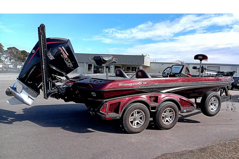 Slide: The Image of 2020 Ranger Z519 boat with trailer, parked outdoors under a clear sky. - 7