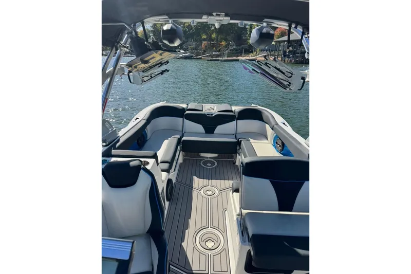 Slide: The Image of 2018 MasterCraft X26 boat interior with luxurious seating on a sunny day. - 2