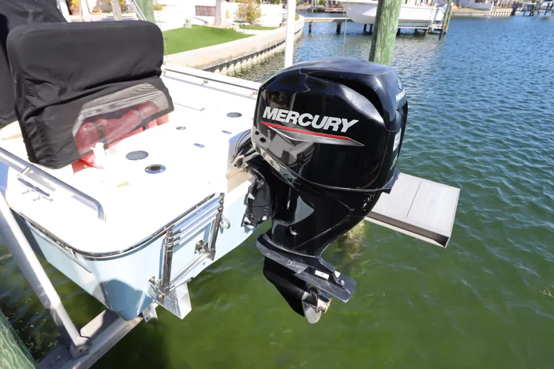 Slide: The Image of 2020 Boston Whaler 150 Montauk with Mercury outboard motor on a dock. - 2