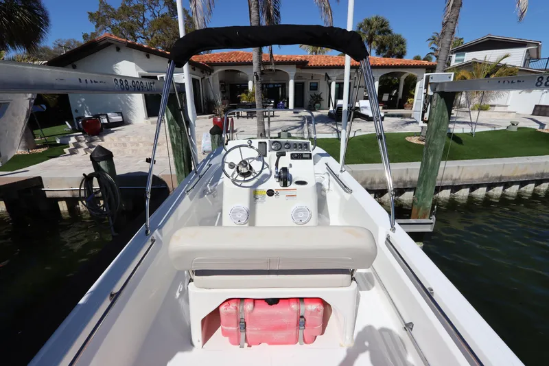 Slide: The Image of 2020 Boston Whaler 150 Montauk boat docked near waterfront home. - 5