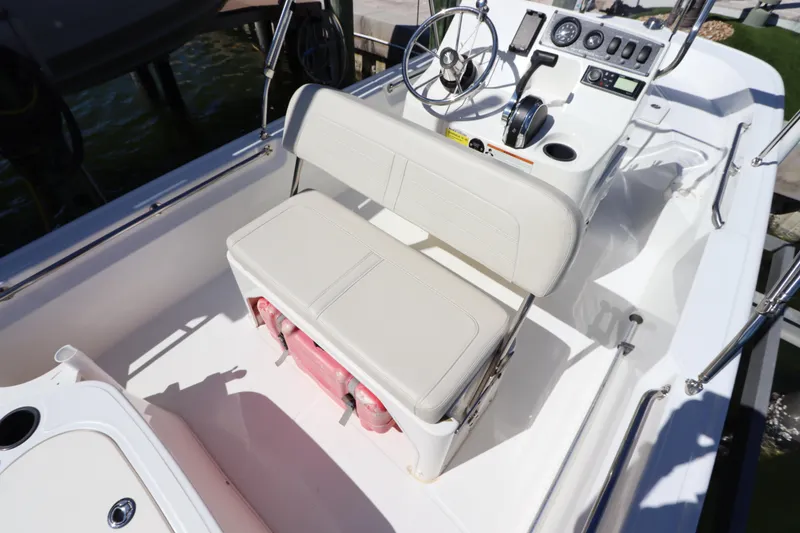 Slide: The Image of 2020 Boston Whaler 150 Montauk boat interior with steering console and seating. - 6