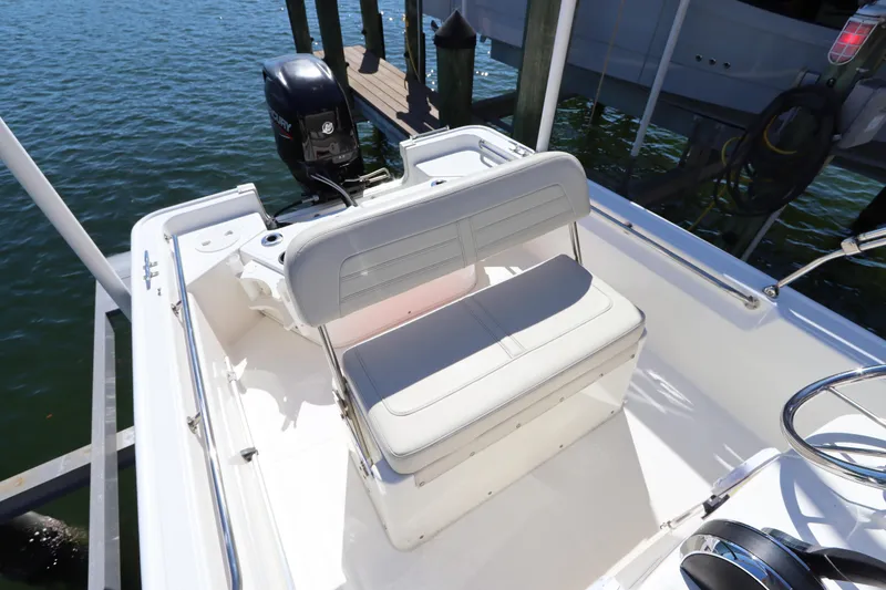 Slide: The Image of 2020 Boston Whaler 150 Montauk boat interior with seating and outboard motor. - 7
