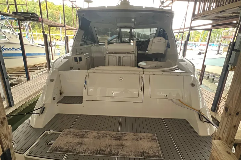 Slide: The Image of 2008 Cruisers Yachts 390 Sports Coupe docked, rear view showing spacious deck and seating area. - 17