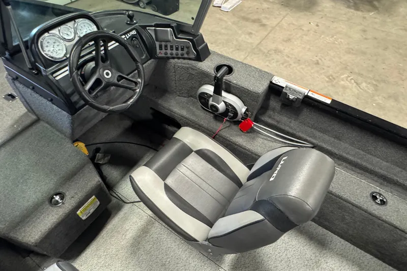 Slide: The Image of 2017 Lund 1750 Rebel XS Sport boat interior with steering wheel and seat. - 10