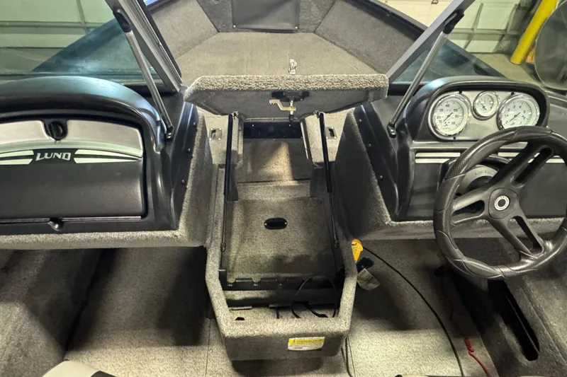 Slide: The Image of 2017 Lund 1750 Rebel XS Sport boat interior with steering wheel and dashboard gauges. - 13