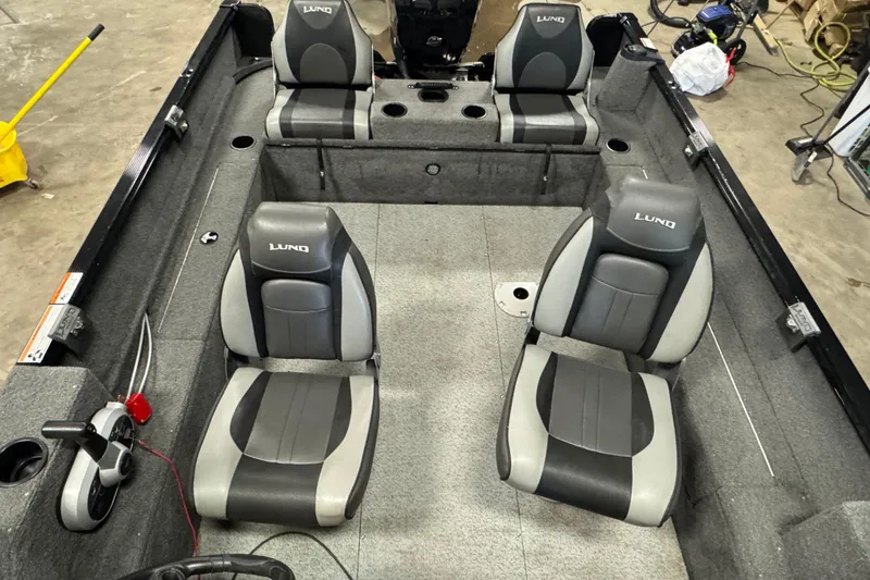 Slide: The Image of 2017 Lund 1750 Rebel XS Sport boat interior with four gray and black seats. - 16