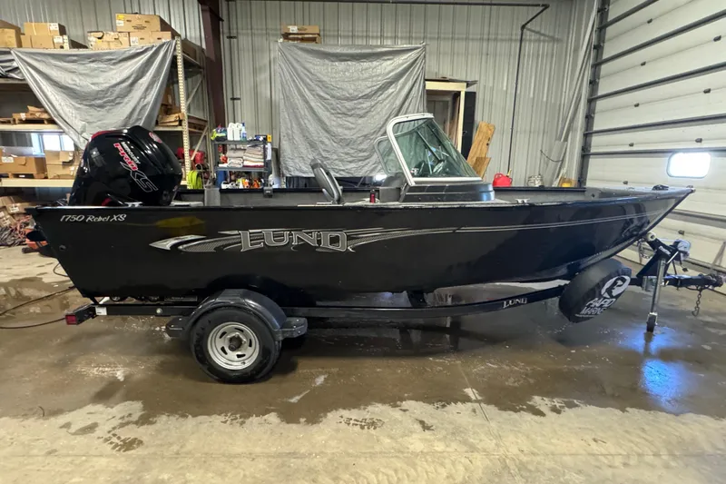 Slide: The Image of 2017 Lund 1750 Rebel XS Sport boat in a garage setting. - 2
