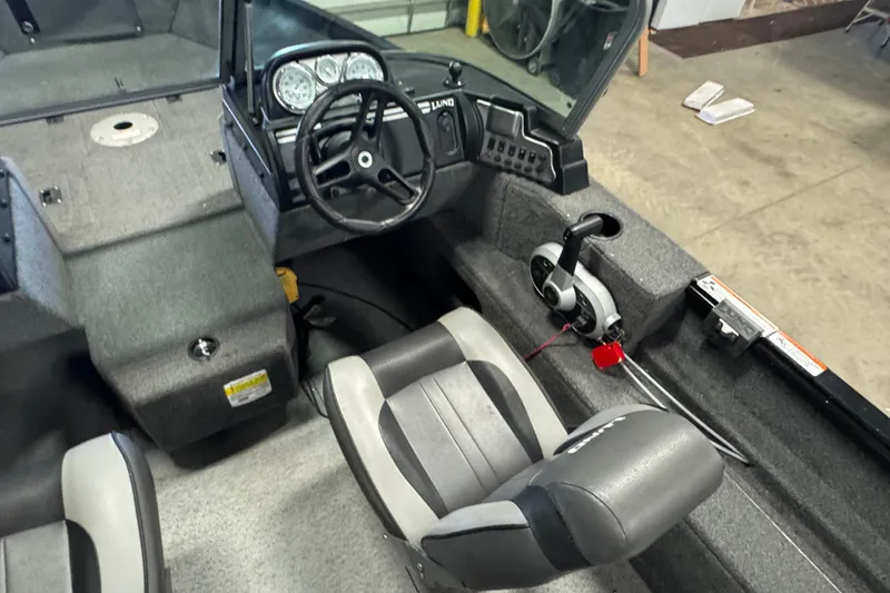 Slide: The Image of 2017 Lund 1750 Rebel XS Sport boat interior with steering wheel and seating. - 7
