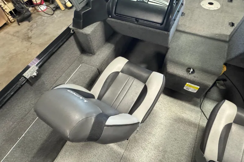 Slide: The Image of 2017 Lund 1750 Rebel XS Sport boat interior with gray seating and carpeted flooring. - 9