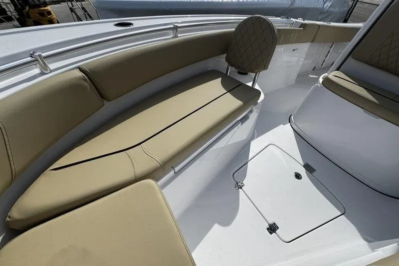 Slide: The Image of 2026 Sportsman Open 232 Center Console boat interior with tan seating and storage compartments. - 10