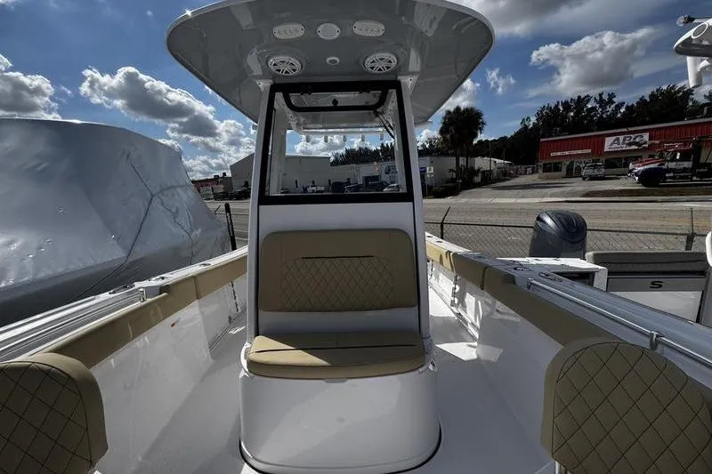 Slide: The Image of 2026 Sportsman Open 232 Center Console boat with seating, under a cloudy sky. - 13