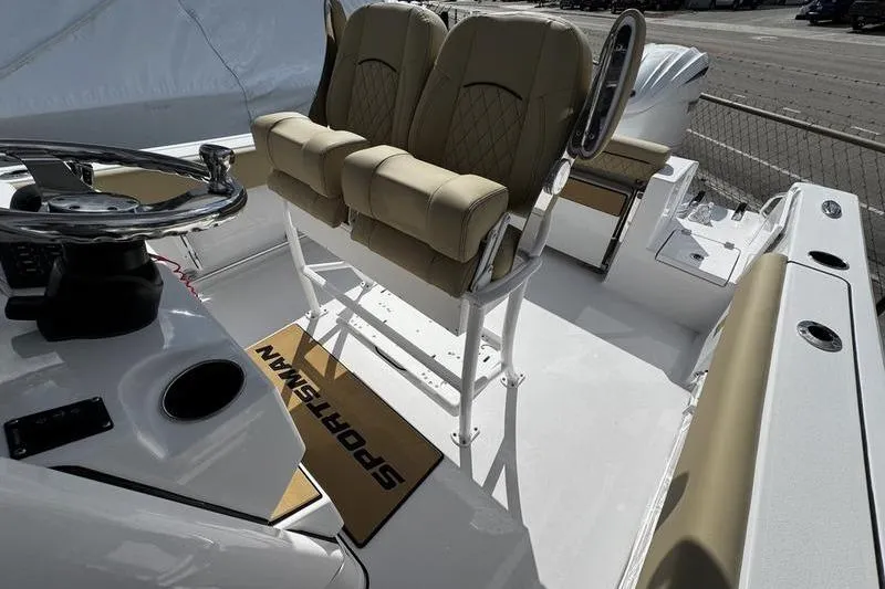 Slide: The Image of 2026 Sportsman Open 232 Center Console boat interior with dual seats and steering wheel. - 14