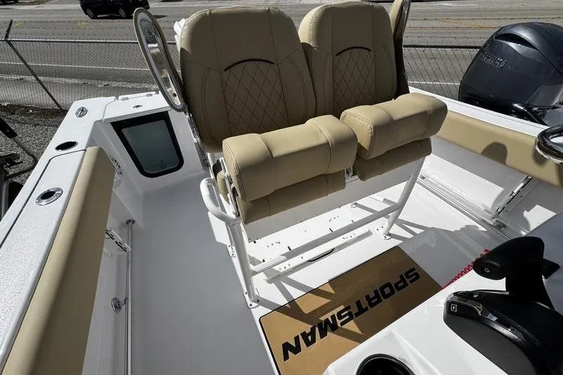 Slide: The Image of 2026 Sportsman Open 232 Center Console boat with beige seating and console view. - 16