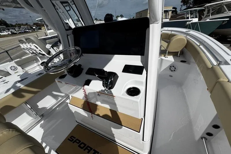Slide: The Image of 2026 Sportsman Open 232 Center Console boat interior with steering wheel and controls. - 18