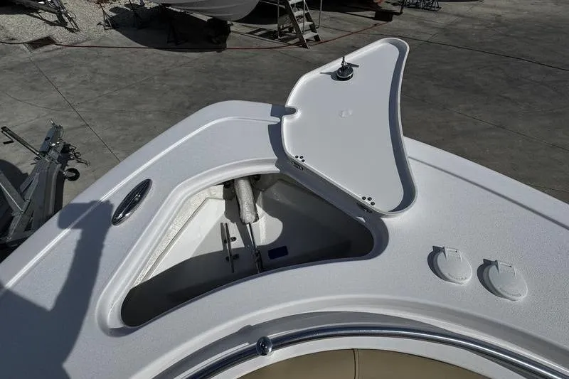 Slide: The Image of Open anchor compartment on 2026 Sportsman Open 232 Center Console boat. - 2