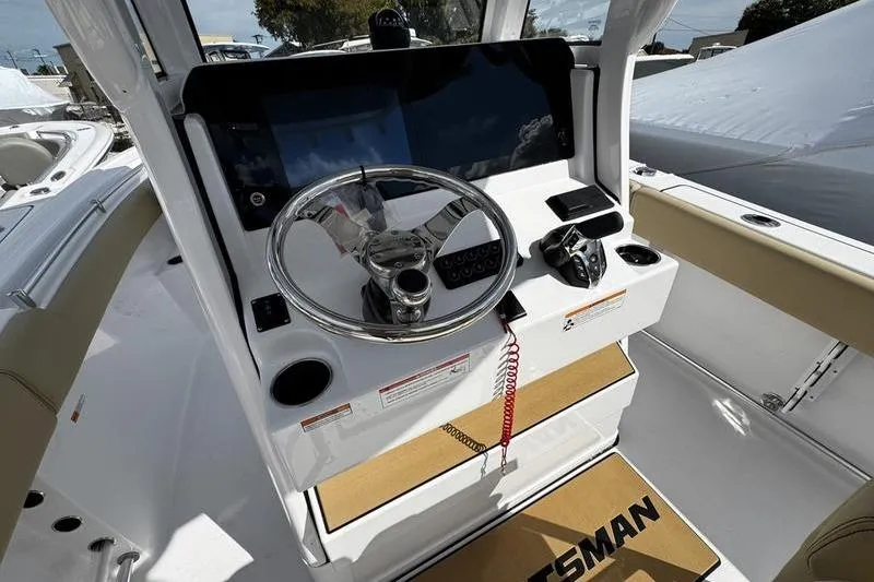 Slide: The Image of 2026 Sportsman Open 232 Center Console boat dashboard with steering wheel and controls. - 21