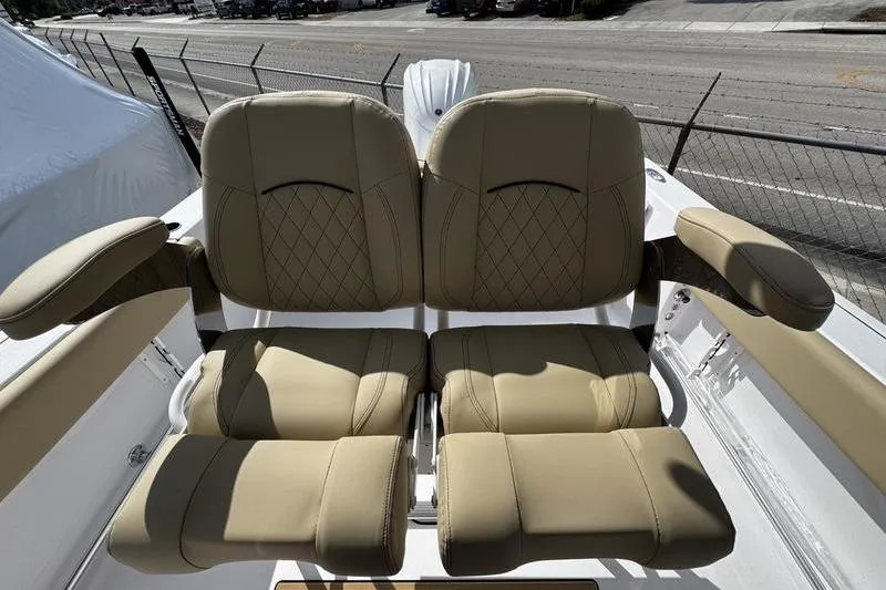 Slide: The Image of 2026 Sportsman Open 232 Center Console boat seats with beige upholstery and armrests. - 22