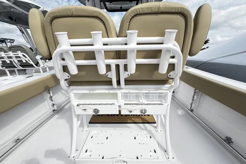 Slide: The Image of 2026 Sportsman Open 232 Center Console boat interior with rod holders and seating. - 23