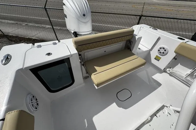 Slide: The Image of 2026 Sportsman Open 232 Center Console boat interior with beige seating and modern design. - 25