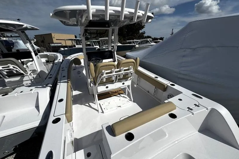 Slide: The Image of 2026 Sportsman Open 232 Center Console boat with beige seating and white deck. - 7