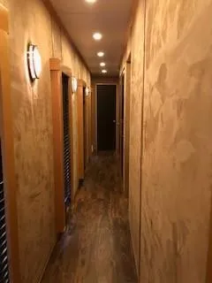 Slide: The Image of Hallway in 2008 Destination Yachts Cruisin, warmly lit, wooden flooring. - 11