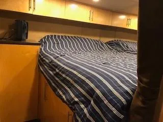 Slide: The Image of Interior of a 2008 Destination Yachts Cruisin yacht with striped bedding. - 20