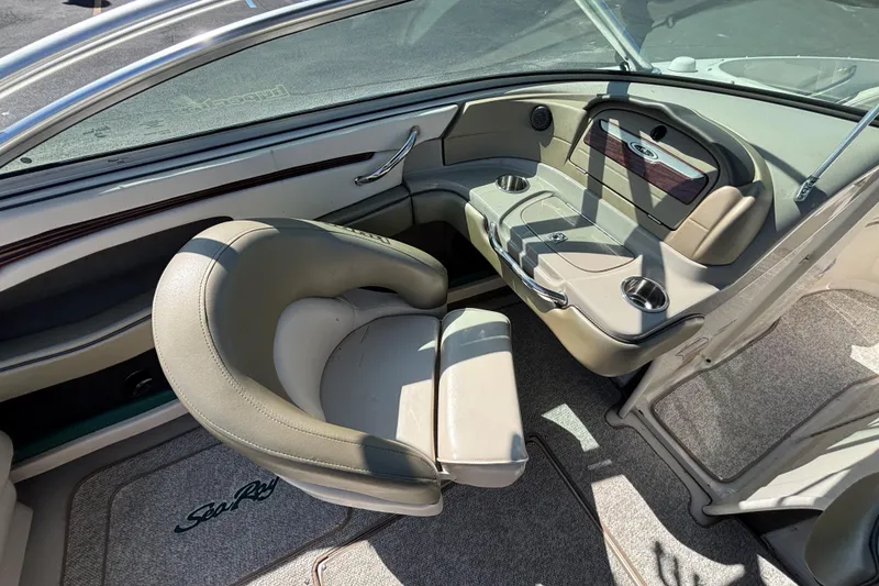 Slide: The Image of Interior of 2005 Sea Ray 220 Select boat with beige seating and cup holders. - 10