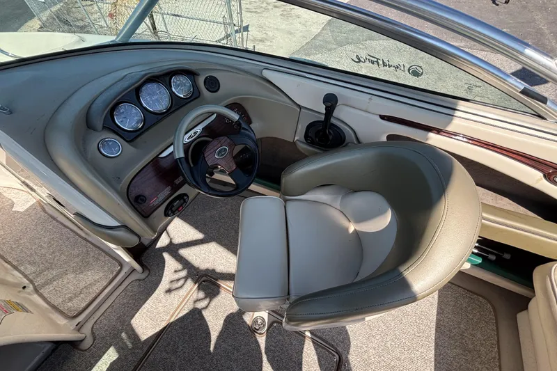 Slide: The Image of 2005 Sea Ray 220 Select boat interior with steering wheel and dashboard controls. - 11