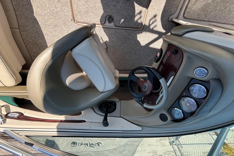 Slide: The Image of 2005 Sea Ray 220 Select boat dashboard with steering wheel and gauges. - 12