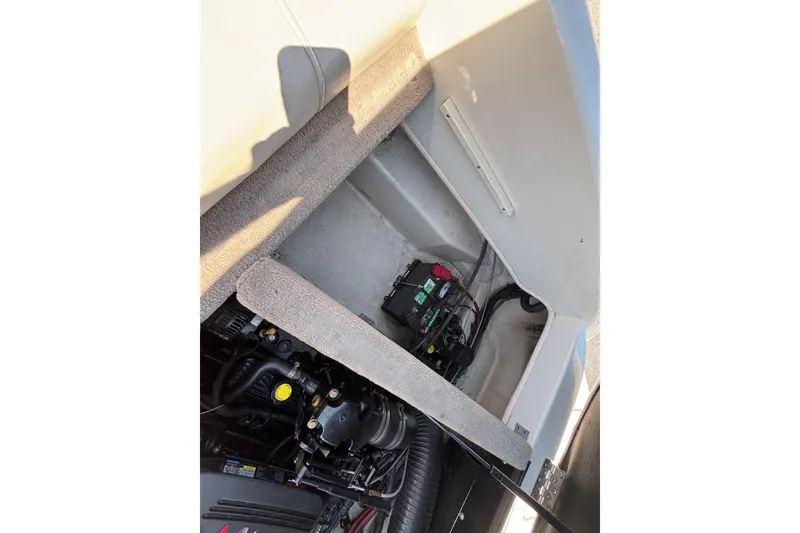 Slide: The Image of 2005 Sea Ray 220 Select boat engine compartment with visible battery and components. - 19